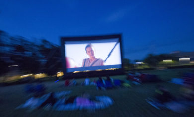 an outdoor movie screen showing the star wars movie