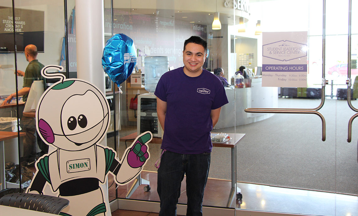 Ben Donan stands in front of the Student Leadership and Service Center, where he works for Associated Student Government as a graphic designer.