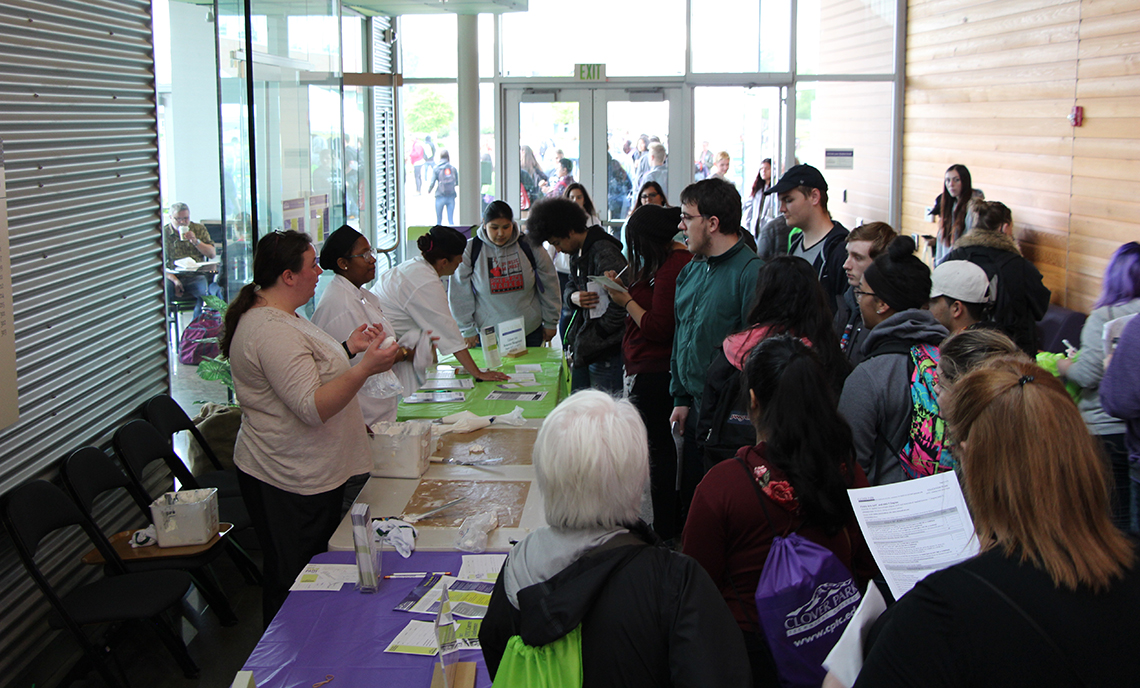 A group of middle school and high school students gather around a Pastry Arts demonstration in Building 23 during the CPTC Career Conference on May 11.