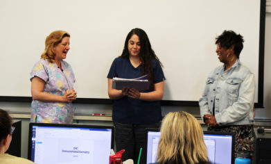 CPTC Medical Histology student Allison Hughes (center) opens the envelope containing her American Society of Clinical Pathologists National Honor Student Award during her morning class on May 17.
