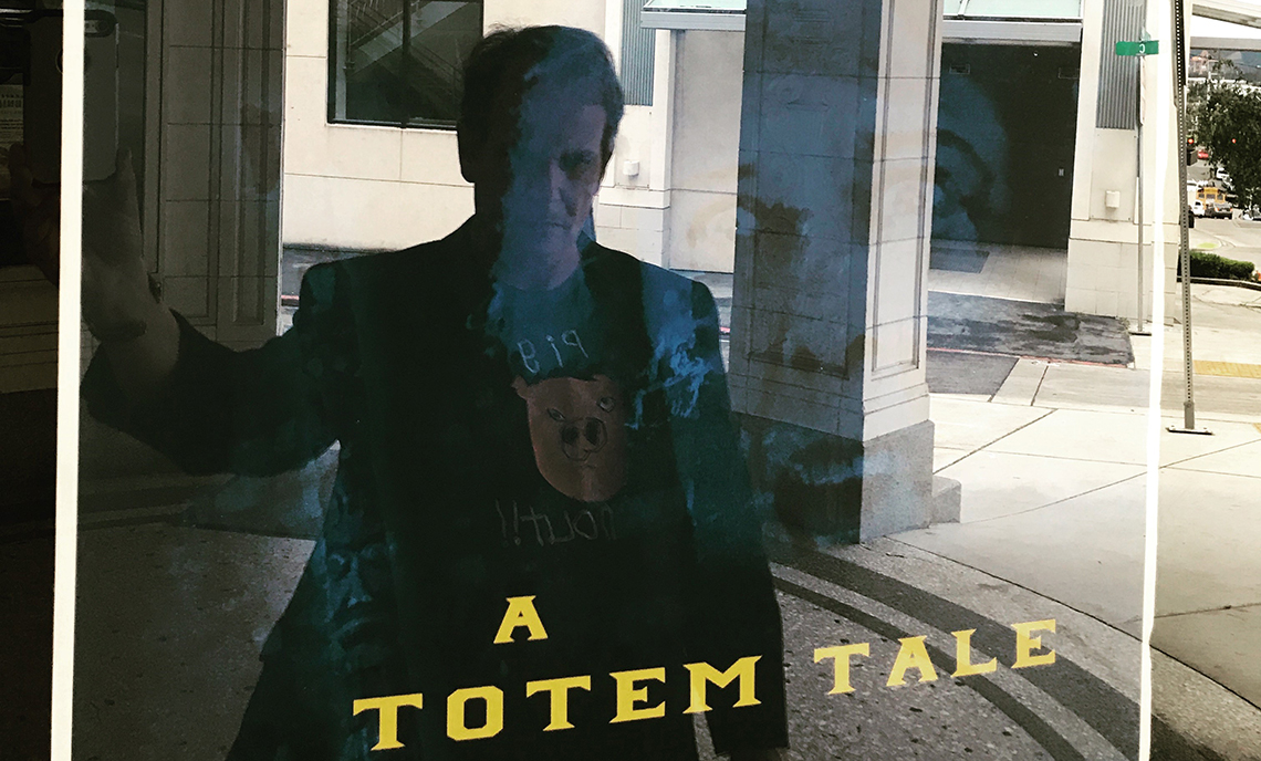 CPTC alum Mick Flaaen can be seen in the reflection of the glass covering a poster promoting the premiere of his documentary "A Totem Tale" at Tacoma's historic Rialto Theater.