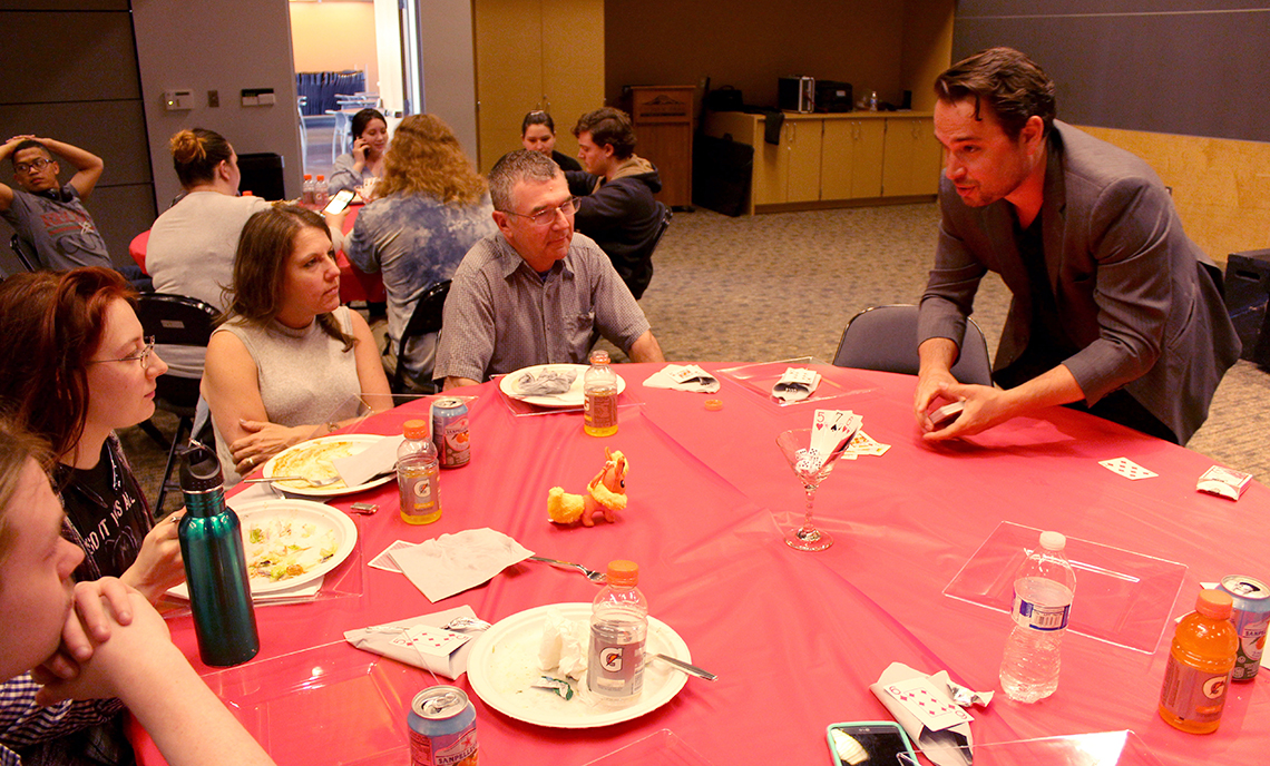 Magician Nate Jester spent the first half of his performance performing tricks to individual table audiences.