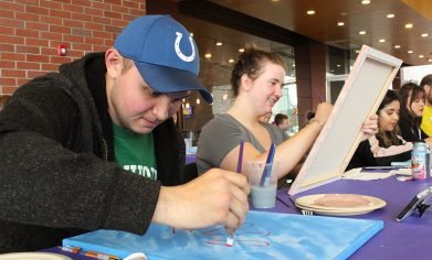 CPTC Dental Assistant student Jessica McElroy and her husband Robbie work on their sunflower paintings at ASG's Paint and Sip event on April 30.