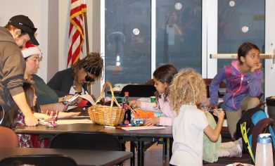 Erika Boquet and her children participate in a craft activity with Sheli Sledge at CPTC's Holiday House event in December 2017.