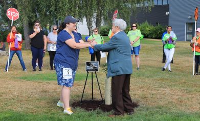 CPTC Environmental Sciences & Technologies Instructor Kathryn Smith and Col. Edward Fritz place a commemorative plaque next to the Garry Oak planted in honor of Andy Fritz.
