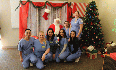 CPTC students take a few minutes out of their day to take a picture with Santa Claus at CPTC's Holiday House event on Thursday, Dec. 6.