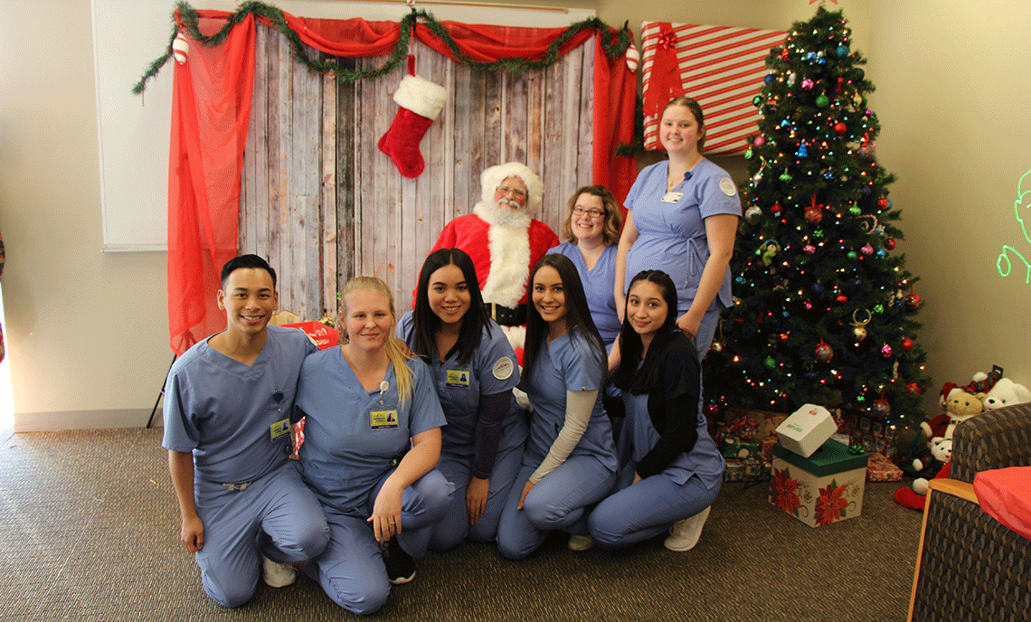CPTC students take a few minutes out of their day to take a picture with Santa Claus at CPTC's Holiday House event on Thursday, Dec. 6.