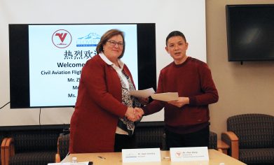 CPTC President Dr. Joyce Loveday and CAFUC Aviation Engineering Institute Deputy Dean Mr. Zou Qiang shake hands after signing a memorandum of understanding.