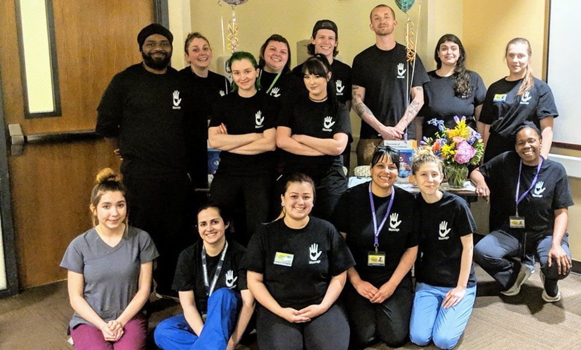 A group of 15 students sit in a hospital room