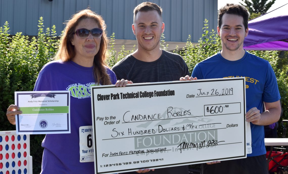 Candance Robles accepts large check for the first ever Andy Fritz Memorial Scholarship alongside Andy’s sons, Caleb and Jared.