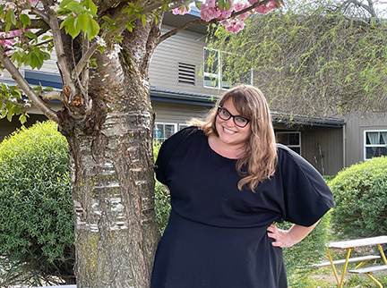 Rachael Butler next to a tree