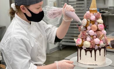 Inessa Suparscaia decorating a three tiered cake