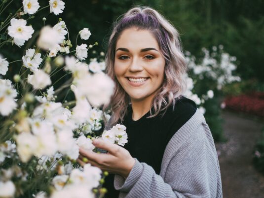 Faith Hulse next to flowers