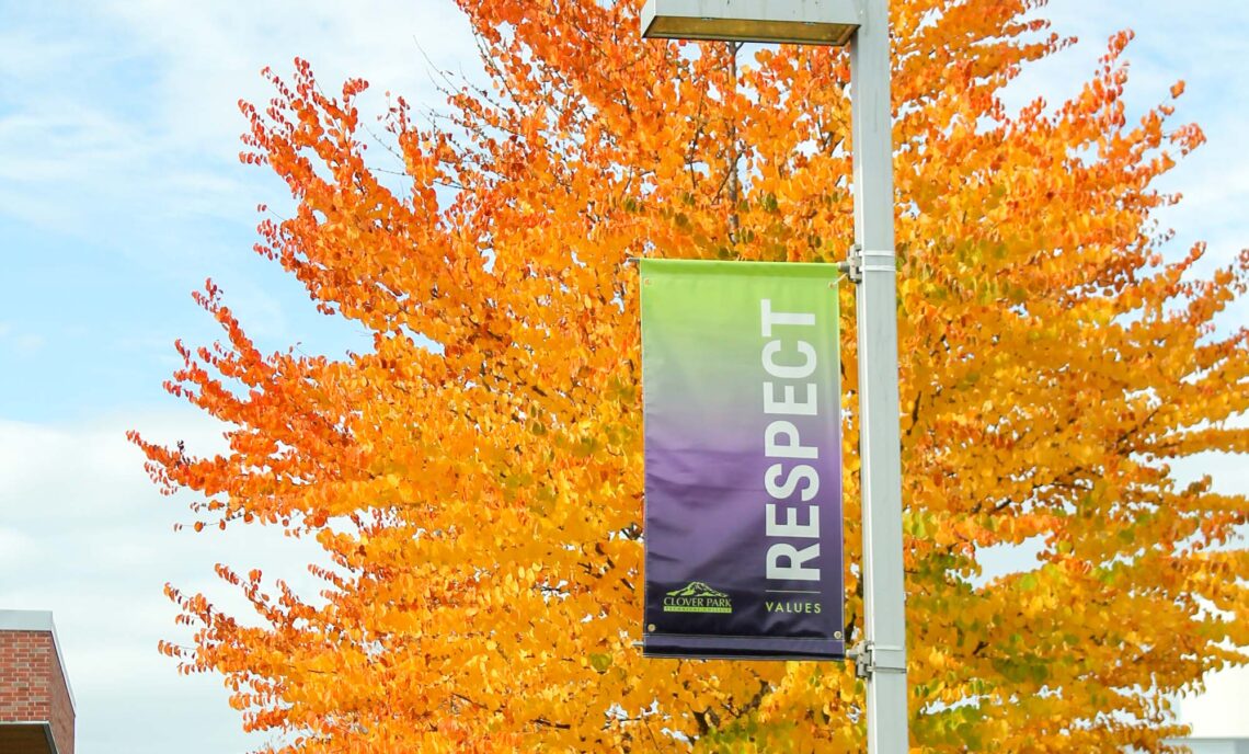 Fall leaves behind a banner that says Respect. Photo by Jeanna Dufour.