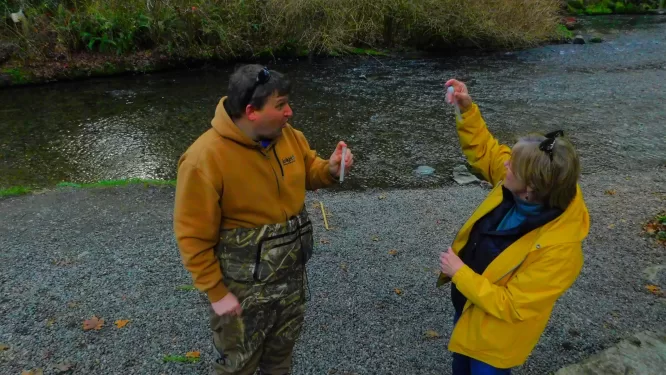 Below:  Dr. Faust shows a teacher how to titrate a water sample.  For the record, the water was *very* cold.