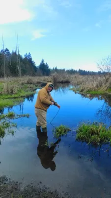 Dr. Faust tests water chemistry at CPTC wetlands
