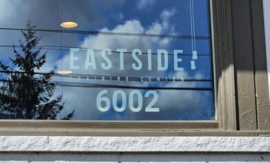 Window decal of 6002 McKinley address sign